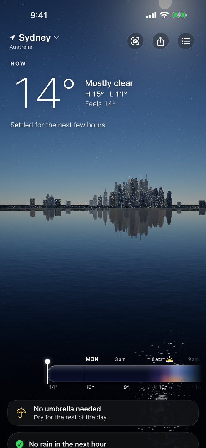 The Sydney skyline at night with lit windows reflected in the water