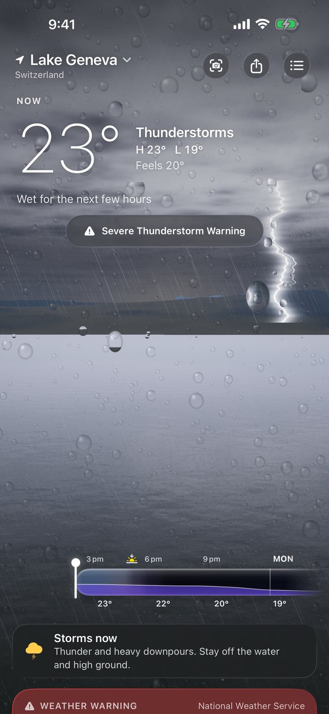 A thunderstorm over Lake Geneva with a lightning bolt and rain beading on the glass